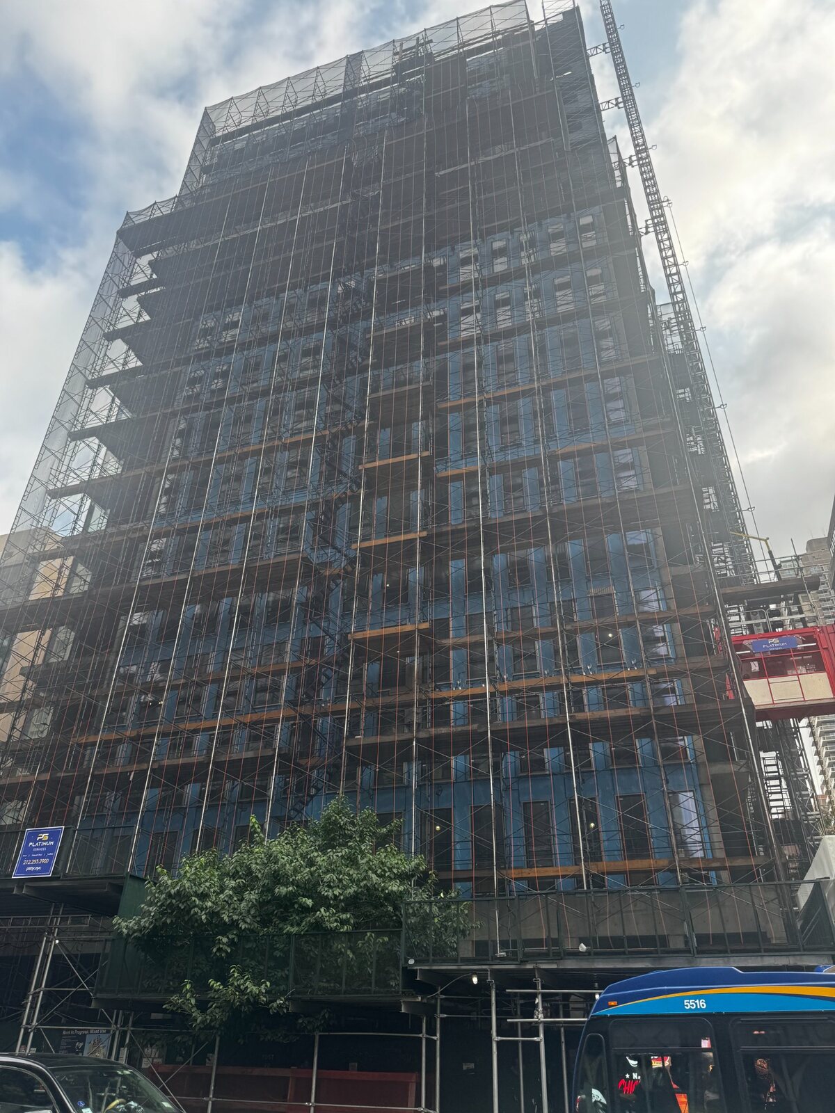 High-rise construction project enclosed by scaffolding in New York City